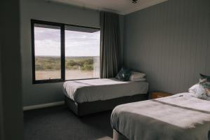 a hotel room with two beds and a window at Parrys Estate at Parry Beach in Parryville