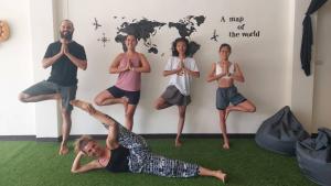 a group of people doing yoga in front of a wall at Outback Hostel & Community in Pai