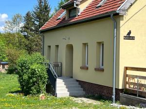 a house with a staircase and a red roof at Perełka in Pieszyce