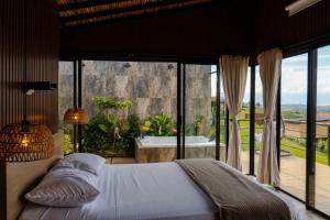 a bedroom with a bed and a view of a tub at Oasis Barichara in Barichara