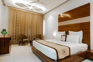 a bedroom with a large bed in a room at THE PRIME PARK in Amravati