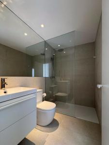 a bathroom with a toilet and a sink and a shower at Superloft in Burjassot +10 photos