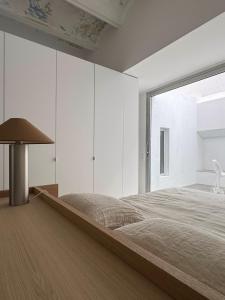 a bedroom with a large bed and a large window at Superloft in Burjasot