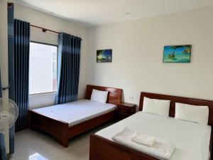Postel nebo postele na pokoji v ubytování Nhà Nghỉ Nhung - Nhung Motel