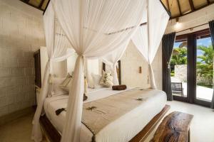 Postel nebo postele na pokoji v ubytování Biu Biu Resort Bali