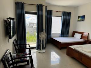 Postel nebo postele na pokoji v ubytování Nhà Nghỉ Nhung - Nhung Motel + 2 fotografie