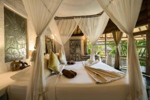 Giường trong phòng chung tại Biu Biu Resort Bali