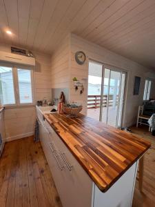 a kitchen with a wooden counter top in a room at Le Chalet Beach Access 8 Pers in Gruissan +6 photos