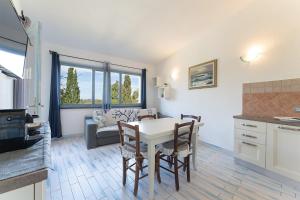a kitchen and living room with a table and chairs at Casa Deruan, 350m to beach in Pinus Village