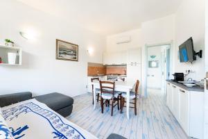 a living room and kitchen with a table and a couch at Casa Deruan, 350m to beach in Pinus Village +9 photos