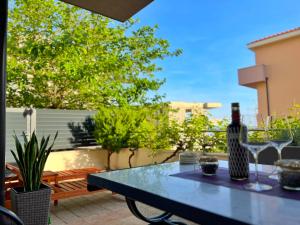 a table with a bottle of wine on a patio at Adria Apartment Makarska in Veliko Brdo