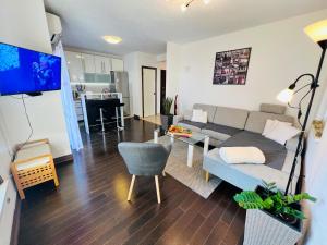 a living room with a couch and a table at Adria Apartment Makarska in Veliko Brdo
