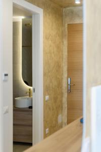 a bathroom with a wooden door and a sink at Studio South - VOGH in Olimp +16 photos
