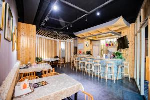a restaurant with wooden walls and tables and chairs at Elite Guest House in the heart of Downtown Ulaanbaatar in Ulaanbaatar