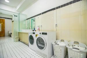 a bathroom with a washing machine and a sink at Elite Guest House in the heart of Downtown Ulaanbaatar in Ulaanbaatar