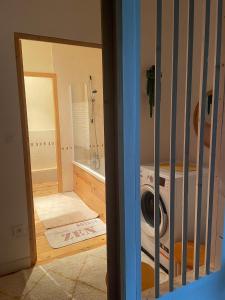 a bathroom with a washing machine in a room at Grande maison conviviale in Neuvic-Entier