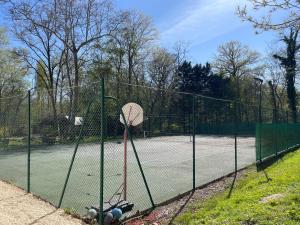 a tennis court with a net on a tennis court at La Chenaie - Les Accacias in Gien