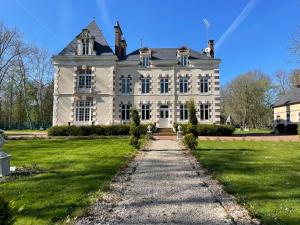 a large white house with a pathway in front at La Chenaie - Les Accacias in Gien