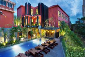 a house with a swimming pool in front of it at Golden Temple Villa in Siem Reap