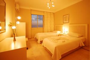 a hotel room with two beds and a window at Goldcity Hotel in Kargicak