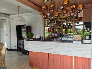 a bar in a restaurant with a counter with alcohol at Pluma in Grzybowo +36 photos