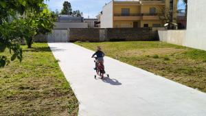 a person riding a bike down a sidewalk at I Tre Pumi in Surbo