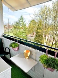 a balcony with two potted plants and a table at Apartament przy Rynku in Sandomierz