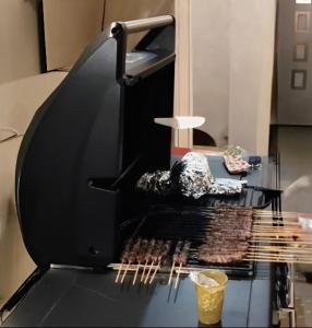a grill with meat and tongs on a table at I Tre Pumi in Surbo