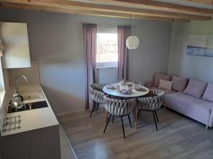 a living room with a table and chairs and a couch at Polanki 22 in Łeba