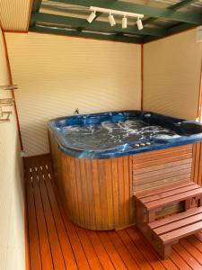 a large jacuzzi tub on a wooden deck at Manyat Peak cottages Kestrel in Porongurup +37 photos