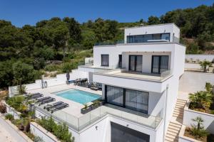 an aerial view of a house with a swimming pool at Villa Oasis in Trogir
