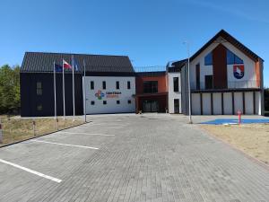 a large parking lot in front of a building at Apartament Green Town Rybno Warmia Mazury in Rybno