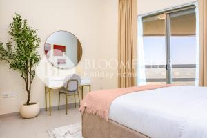 a bedroom with a bed and a mirror and a desk at Bloomfields 1Br Azure Stay Ajwan Soul Beach Access in Abu Dhabi
