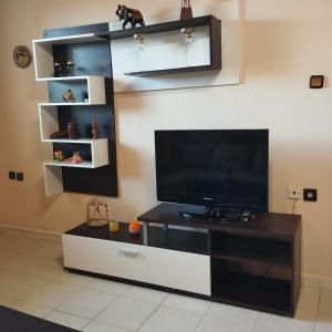 a living room with a flat screen tv on a entertainment center at Michael House in Kavala