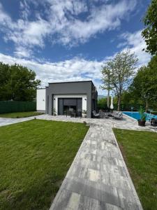 a black and white house with a yard at Villa Sofia in Bihać