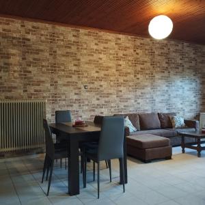 a living room with a table and a couch at Michael House in Kavala