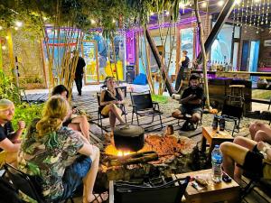 a group of people sitting around a fire pit at Homestay ECO MAY5 TRAVEL in Ha Long