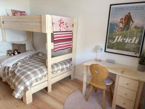 a bedroom with a bunk bed and a desk at Alpen family apartment Bergfreunde near skilift and golf course in Bad Kleinkirchheim