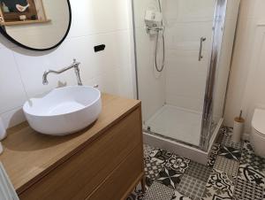 a bathroom with a sink and a shower at Domki całoroczne z baliami i sauną Leśny Czar in Raków +23 photos