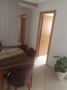 a dining room with a table and chairs and a door at جوهرة البحر in Bel Aroussi