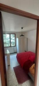 a reflection of a bedroom with a red bed in a mirror at Villa Maison de campagne 04 Vacheres Luberon 3 chambres 8 personnes in Vachères