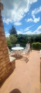 a patio with a table and chairs on a patio at Villa Maison de campagne 04 Vacheres Luberon 3 chambres 8 personnes in Vachères