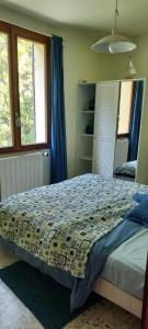 a bedroom with a bed in a room with windows at Villa Maison de campagne 04 Vacheres Luberon 3 chambres 8 personnes in Vachères