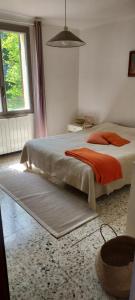 a bedroom with a bed and a large window at Villa Maison de campagne 04 Vacheres Luberon 3 chambres 8 personnes in Vachères