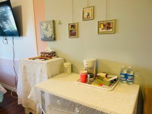 two tables with white table cloths on them in a room at Lily's garden in Charlottetown