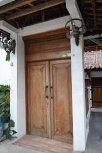 a wooden door of a house with a ceiling at Joglo Turen Villa in Ngaglik +8 photos