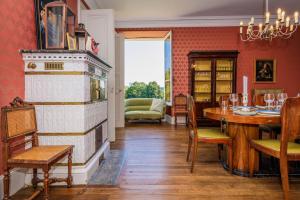 a dining room with a table and a fireplace at Chateau de la Guerinchie, beautiful 7 bedroom castle in the heart of the Dordogne in Thiviers