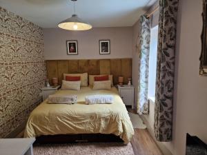 a bedroom with a bed with two pillows on it at The Drey by Blake view holidays, a peaceful boutique retreat, 3 miles from Ennerdale- small twin or king bed available in Arlecdon