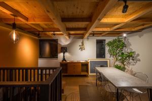 a dining room with wooden ceilings and a table at HOTEL Sauna&Living in Iwanuma
