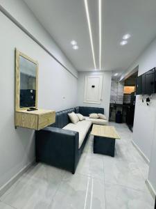 a living room with a couch and a table at The most wonderful view of Brital View North Coast in El Alamein +7 photos